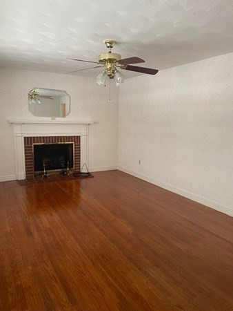 70 Woodcrest Road Springfield, MA 01129 - Photo 11 of 22 a view of empty room with wooden floor and fireplace