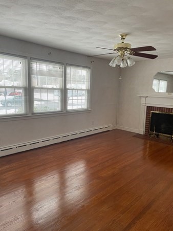 70 Woodcrest Road Springfield, MA 01129 - Photo 12 of 22 an empty room with wooden floor fan and windows