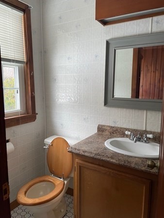 70 Woodcrest Road Springfield, MA 01129 - Photo 5 of 22 a bathroom with a toilet sink and mirror