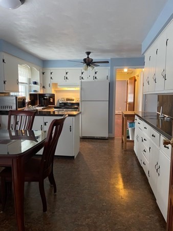 70 Woodcrest Road Springfield, MA 01129 - Photo 6 of 22 a kitchen with stainless steel appliances kitchen island granite countertop a table chairs sink and cabinets