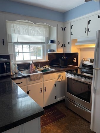 70 Woodcrest Road Springfield, MA 01129 - Photo 7 of 22 a kitchen with stainless steel appliances kitchen island granite countertop a stove a sink and a microwave