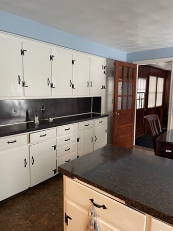 70 Woodcrest Road Springfield, MA 01129 - Photo 10 of 22 a kitchen with granite countertop white cabinets and white appliances