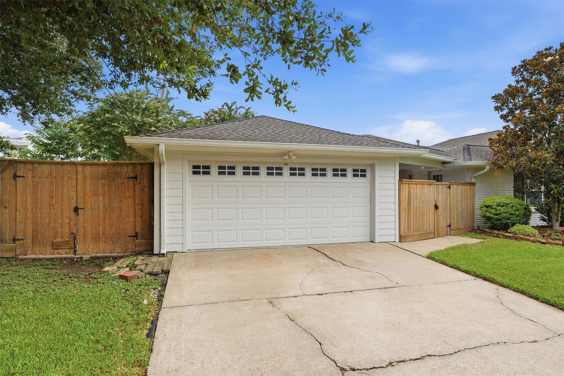 4701 Hummingbird Street Houston, TX 77035 - Photo 24 of 28 The two car garage is attached to the house via a covered walkway. A double-wide driveway allows for two additional cars to be parked off the street.