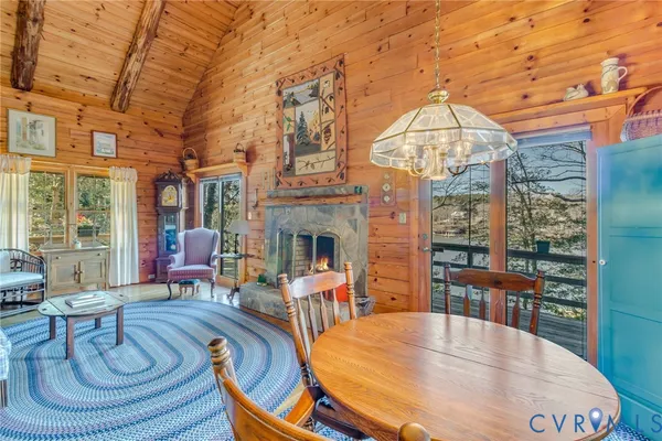 a living room with fireplace furniture and a large window