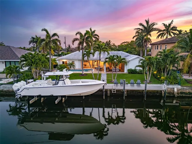 a view of a patio with table and chairs and potted plants