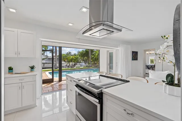 a view of a kitchen with a sink and dishwasher a stove top oven with wooden floor