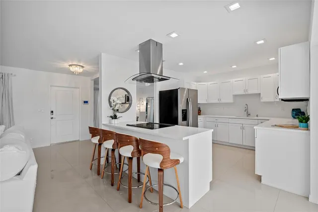 a kitchen with a stove a table and chairs