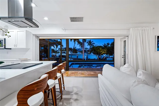 a living room with furniture a rug and a window