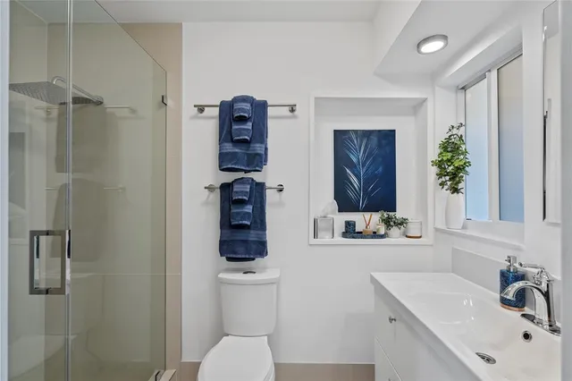 a bathroom with a sink toilet and shower