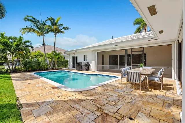 a view of a house with backyard porch and sitting area