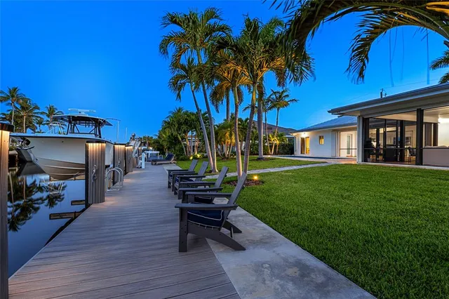 a view of a house with backyard porch and sitting area