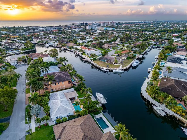 an aerial view of residential houses with outdoor space and river