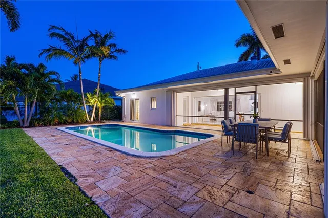 a swimming pool with outdoor seating and yard
