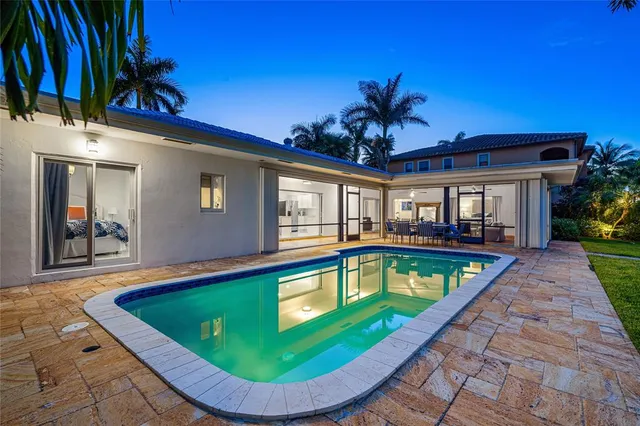 a view of a house with swimming pool and porch