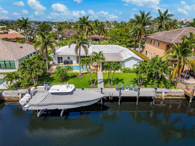 an aerial view of a house with swimming pool patio and outdoor seating