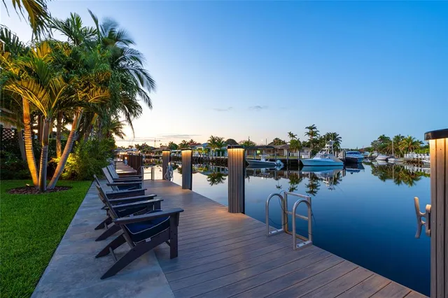 a park with water view and a table and chairs