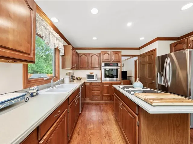 a kitchen with stainless steel appliances a sink stove and refrigerator