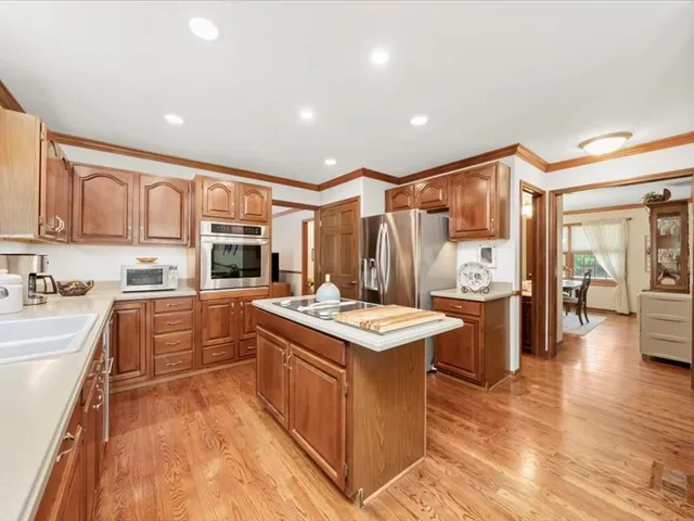 a kitchen with stainless steel appliances granite countertop a stove and cabinets