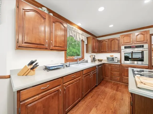 a kitchen with a sink a counter top space and cabinets