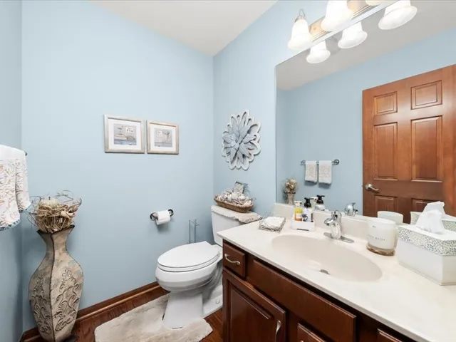 a bathroom with a sink a toilet and a mirror