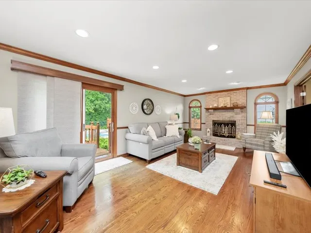 a living room with furniture fireplace and flat screen tv