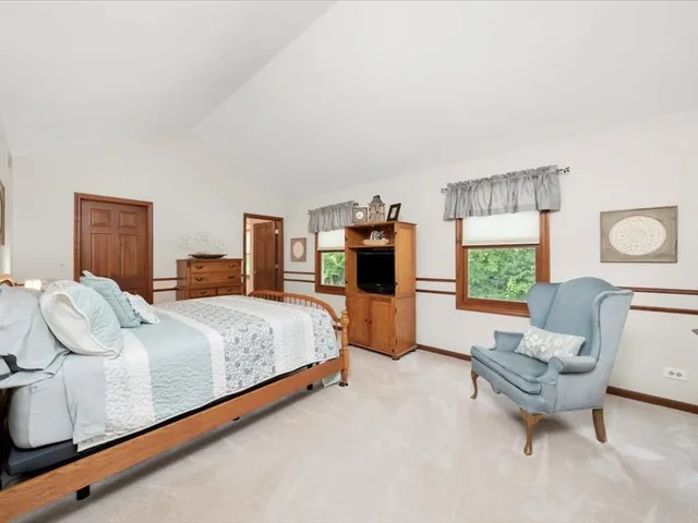 a spacious bedroom with a bed and window