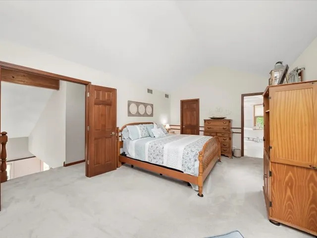 a bedroom with a bed and a refrigerator