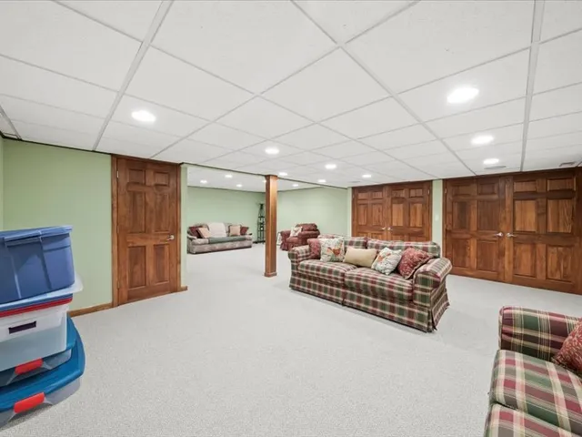 an aerial view of a house with a garden and large trees