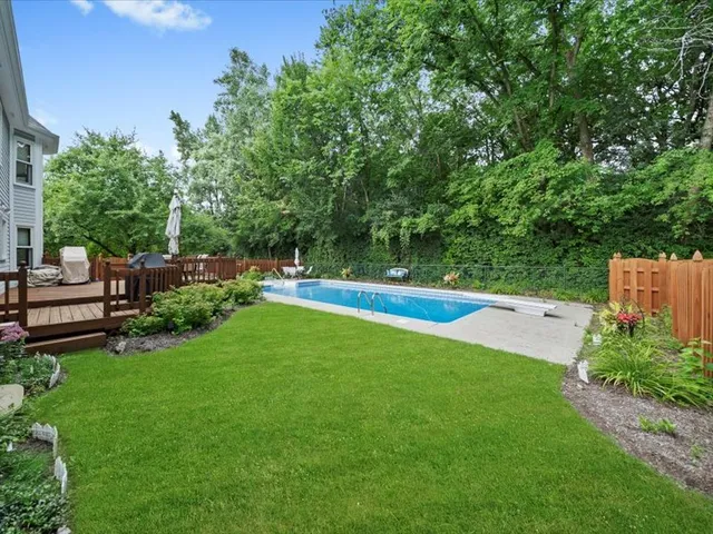 a view of swimming pool with outdoor seating and plants