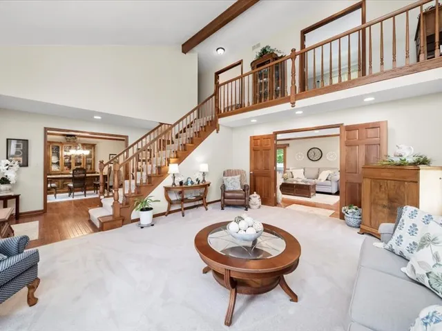 a living room with furniture and a large mirror