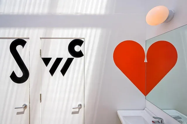 a view of a big room with windows and white walls