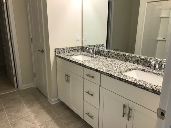 2 Jackson Drive, Unit 72 Upton, MA 01568 - Photo 11 of 13 a bathroom with a granite countertop sink and a mirror