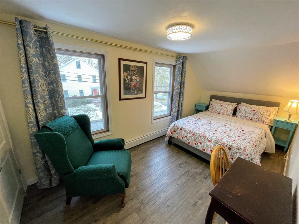 8 Pike Street Hopkinton, MA 01748 - Photo 18 of 34 a bedroom with a bed and a chair
