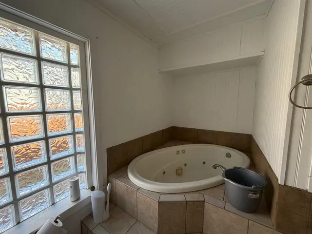 a white bath tub sitting next to a window