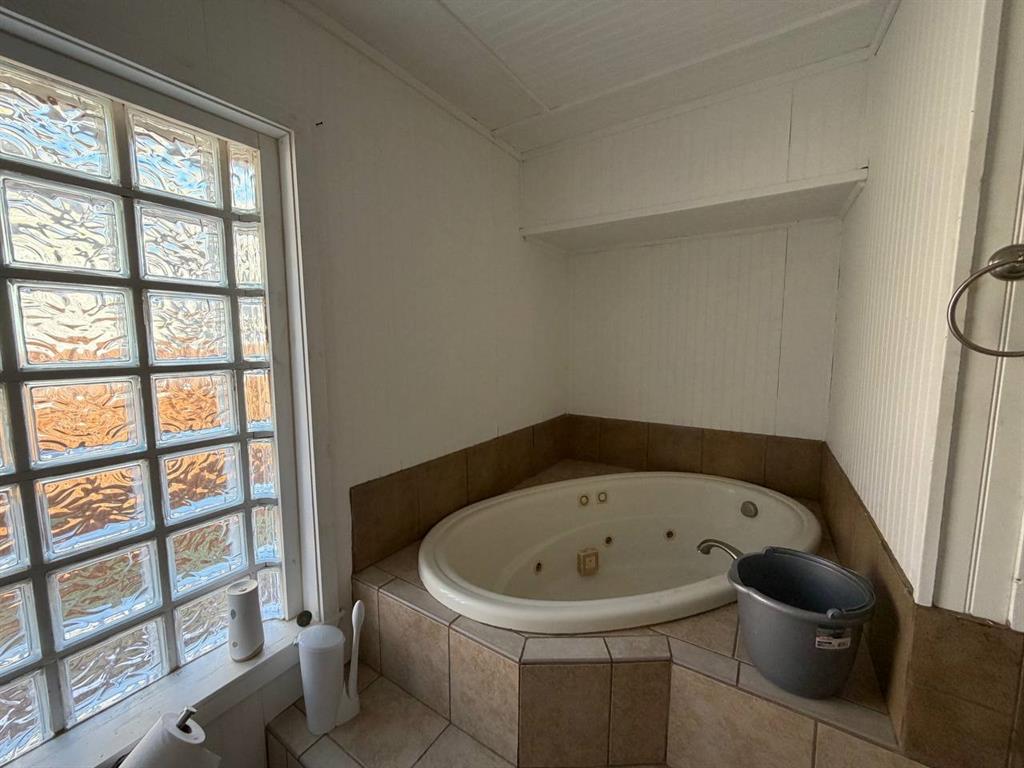812 Tennessee Street Graham, TX 76450 - Photo 11 of 21 a white bath tub sitting next to a window
