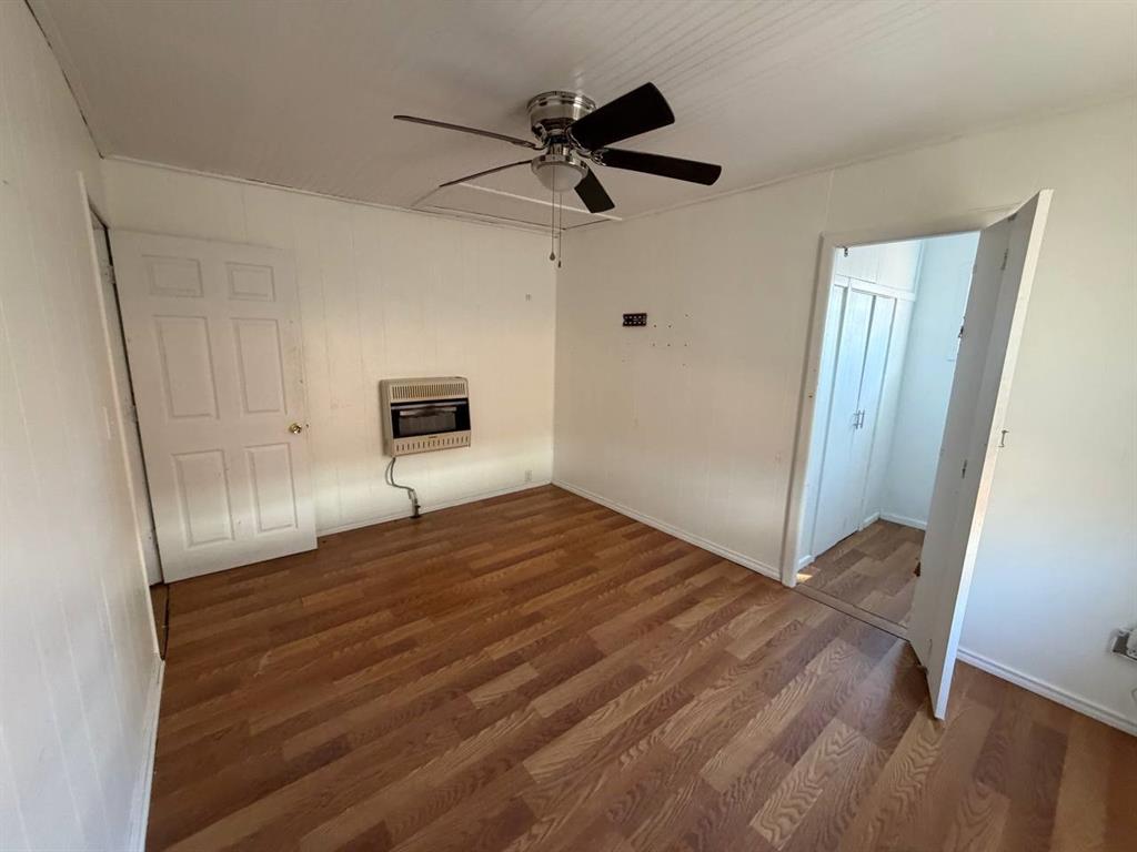 812 Tennessee Street Graham, TX 76450 - Photo 13 of 21 a view of empty room with wooden floor and fan