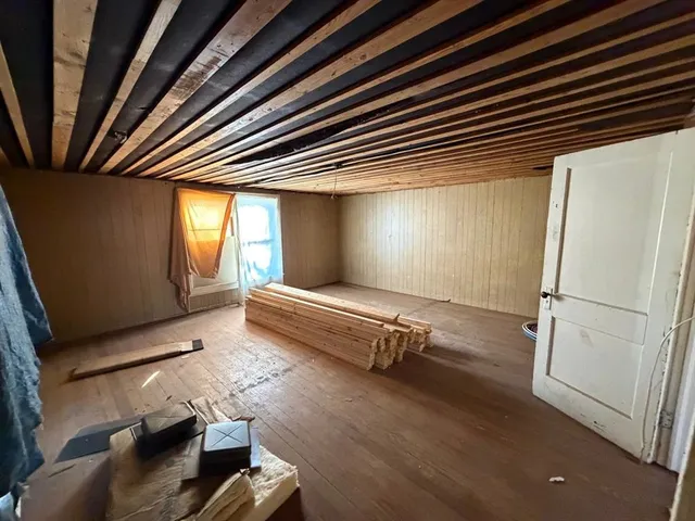 a room with wooden floor and furniture