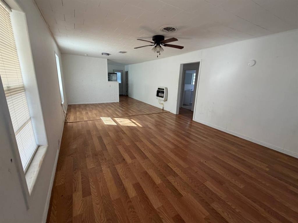 812 Tennessee Street Graham, TX 76450 - Photo 3 of 21 a view of empty room with wooden floor