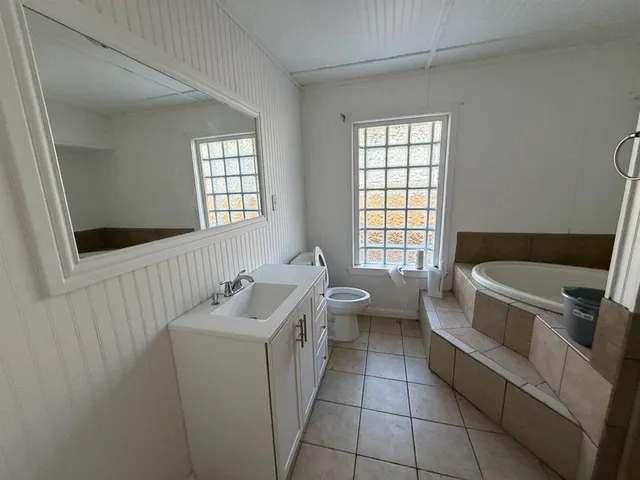 a bathroom with a sink a toilet and bathtub