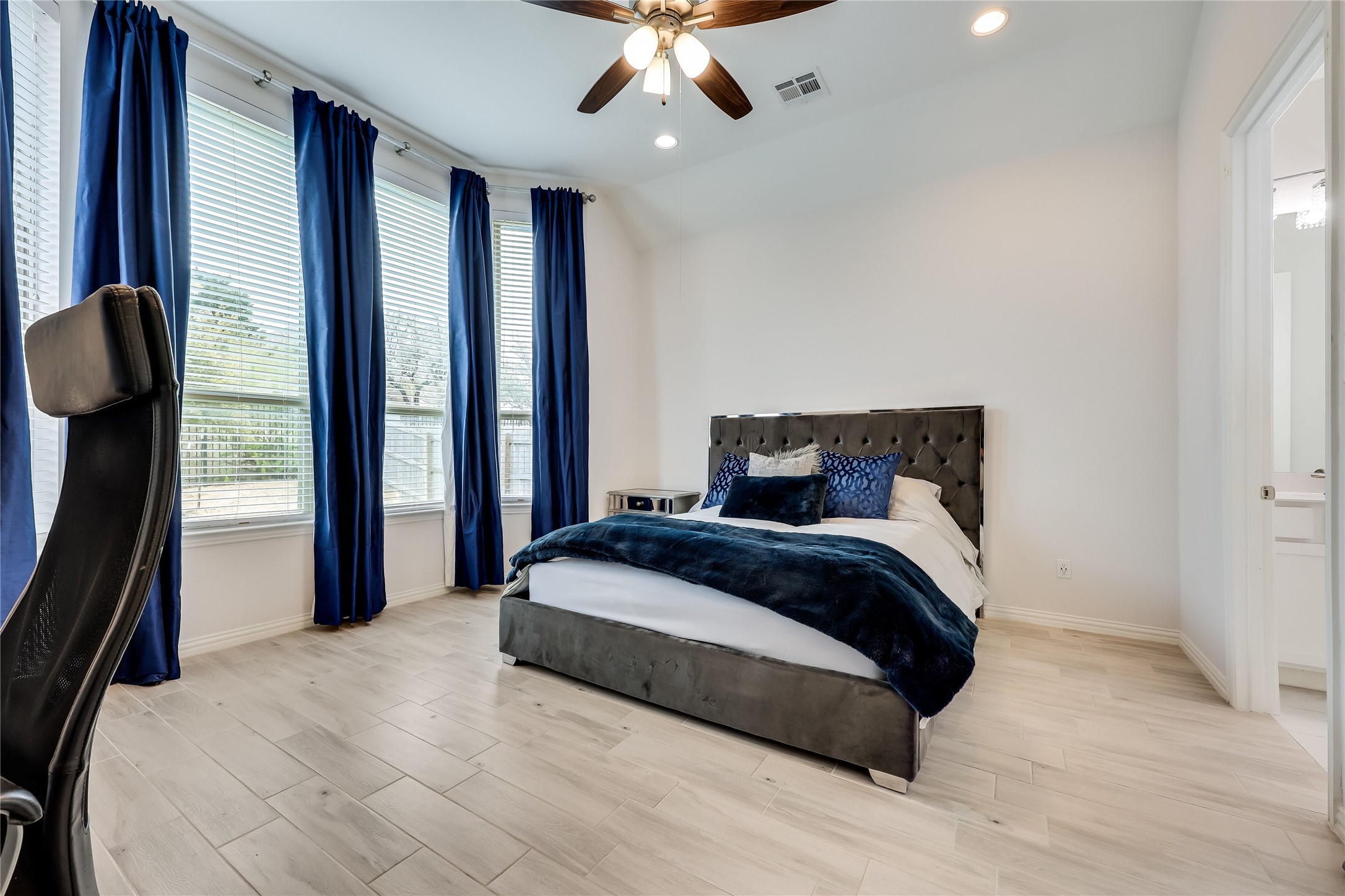 7705 Pace Ravine Drive Lago Vista, TX 78645 - Photo 14 of 40 Primary bedroom with recessed lighting, light wood-type flooring, a ceiling fan, and lofted ceiling