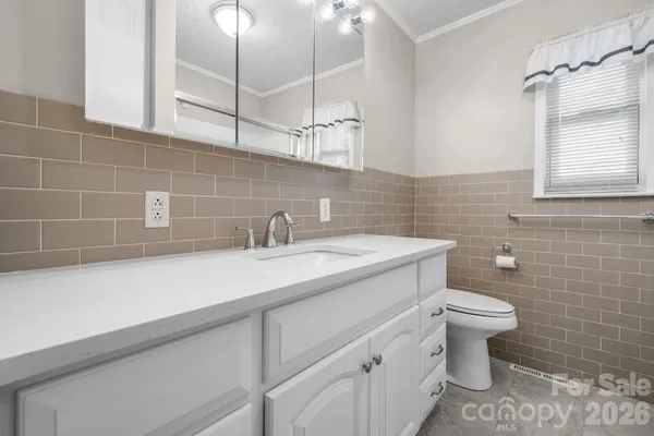 a bathroom with a sink and mirror