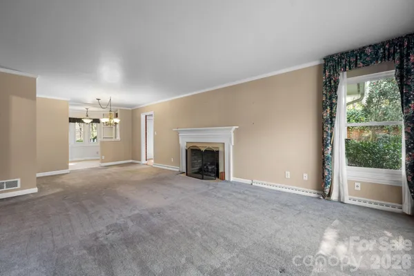 a view of a livingroom with an empty space and a fireplace