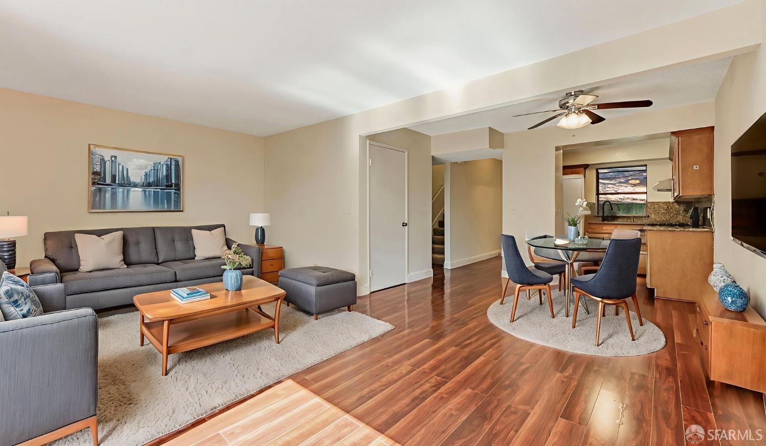 a living room with furniture and a wooden floor