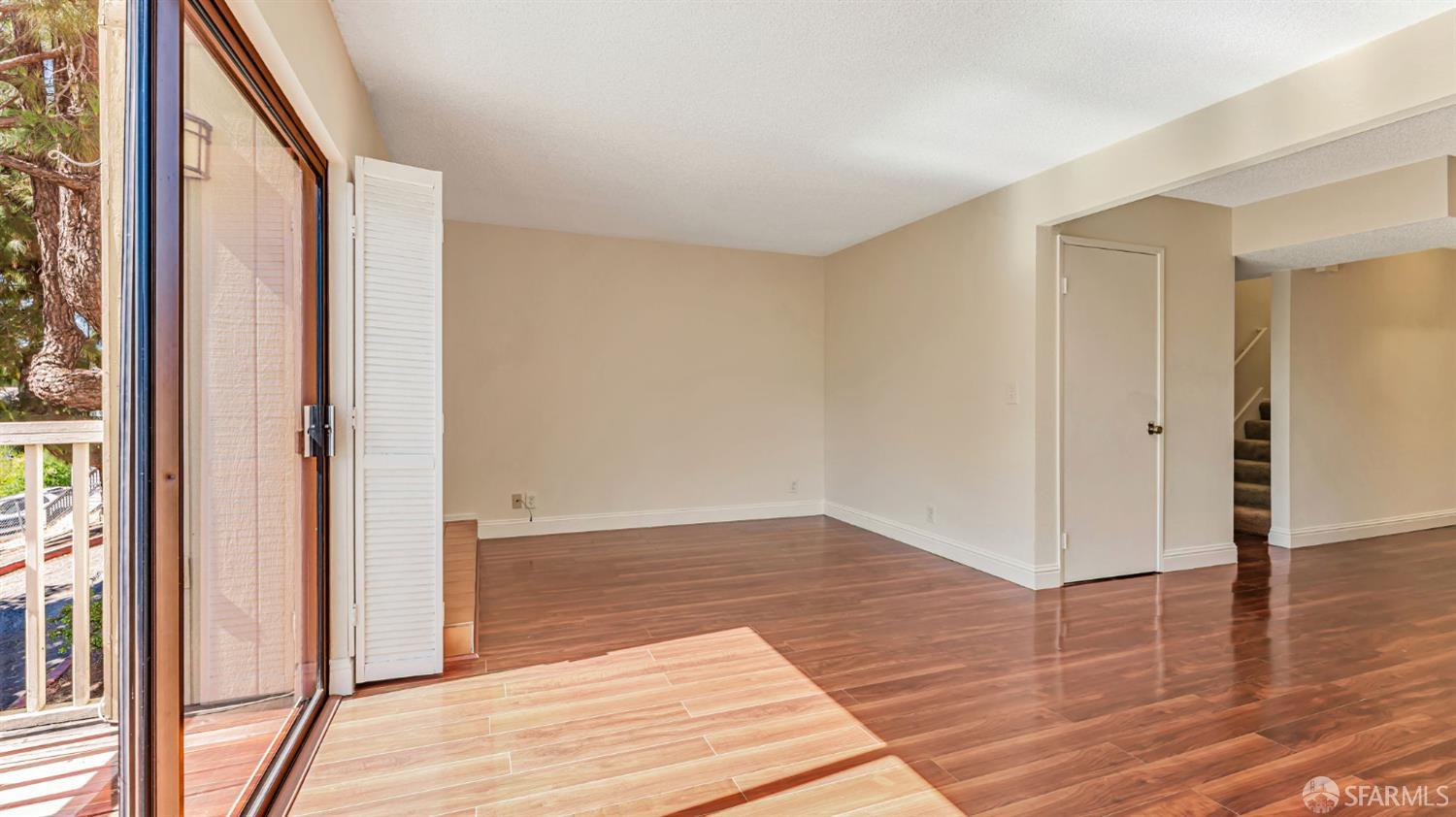 107 Alice Lane El Sobrante, CA 94803 - Photo 12 of 39 a view of an empty room with wooden floor and a window