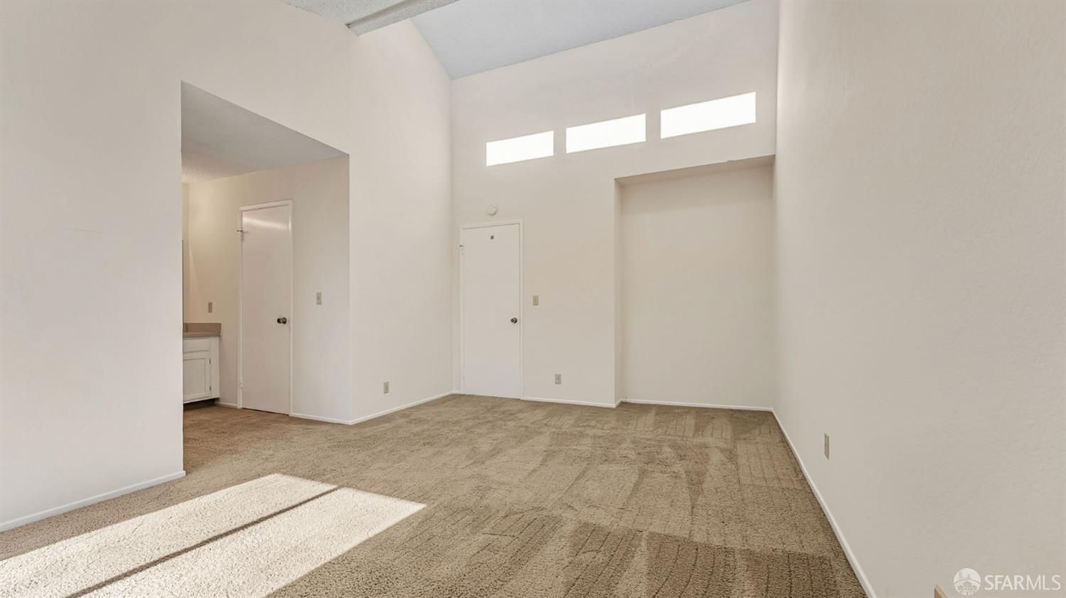 107 Alice Lane El Sobrante, CA 94803 - Photo 25 of 39 an empty room with wooden floor and mirror