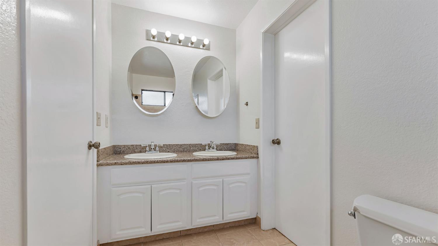 107 Alice Lane El Sobrante, CA 94803 - Photo 30 of 39 a spacious bathroom with a double vanity sink and a mirror
