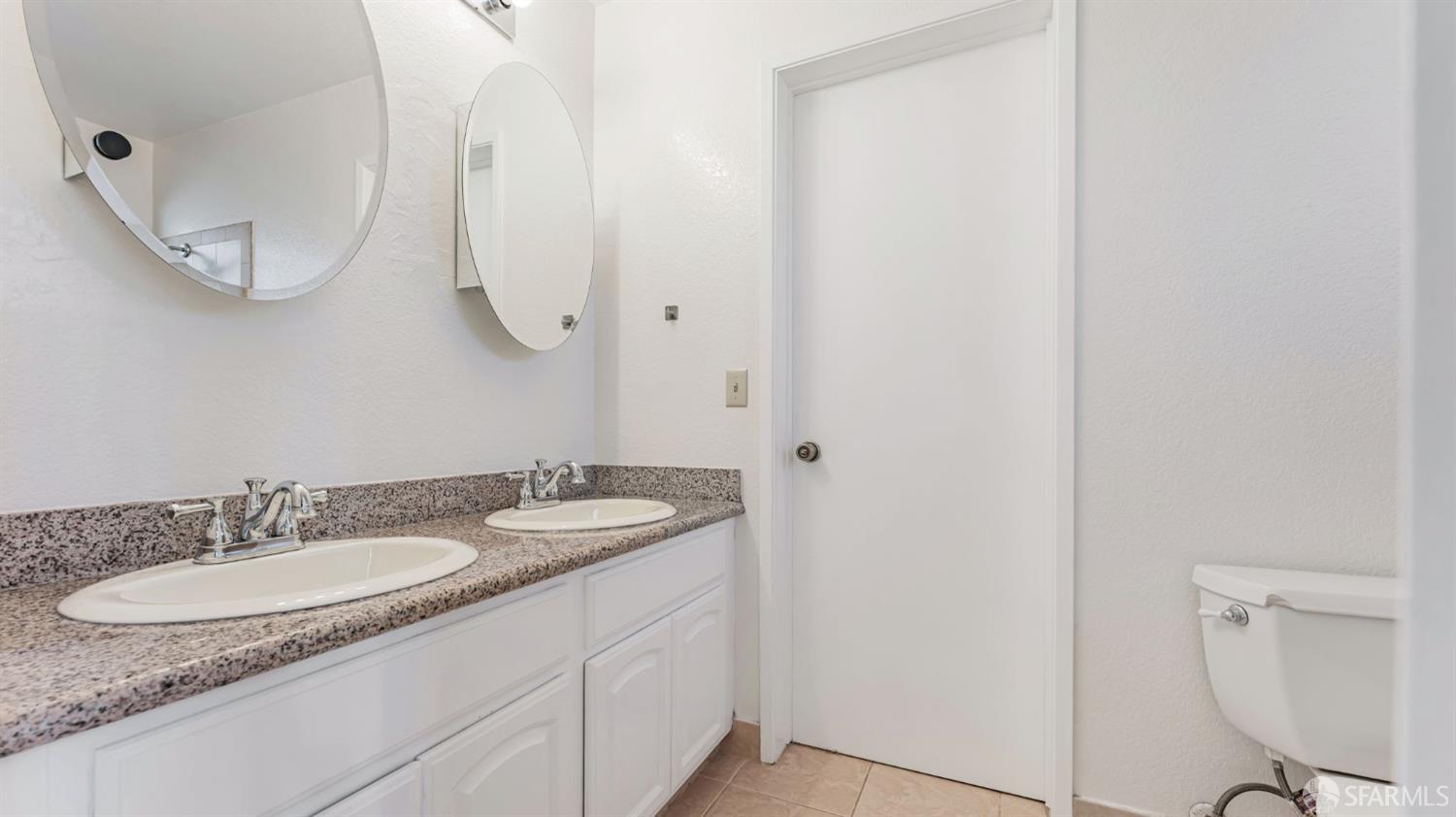 107 Alice Lane El Sobrante, CA 94803 - Photo 34 of 39 a bathroom with a granite countertop sink and a mirror