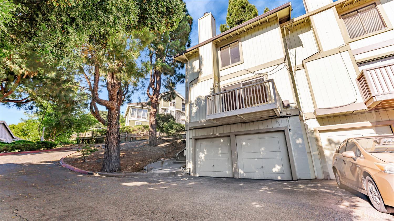 107 Alice Lane El Sobrante, CA 94803 - Photo 4 of 39 a view of a house with a large tree