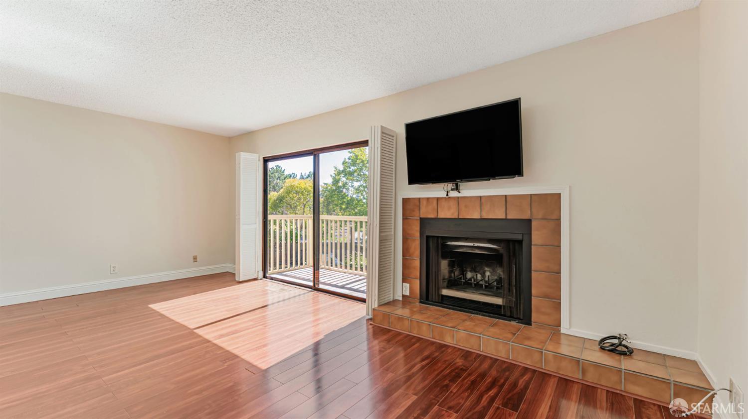 107 Alice Lane El Sobrante, CA 94803 - Photo 10 of 39 a living room with a fireplace and a flat screen tv