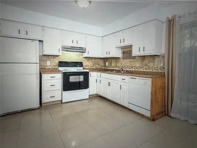 a kitchen with stainless steel appliances a stove sink and refrigerator